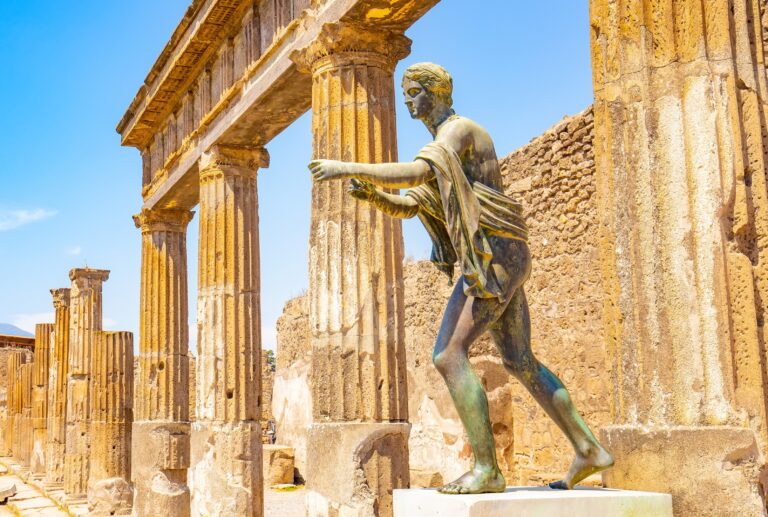 Pompeii city skyline and bronze Apollo statue, Italy